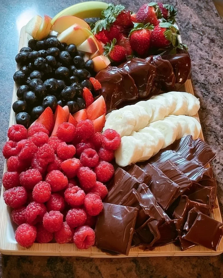 A beautifully arranged Fruit and Chocolate Tray with a variety of fruits and chocolate.