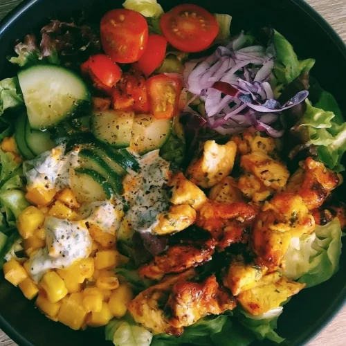 Delicious healthy chicken salad with fresh vegetables and dressing