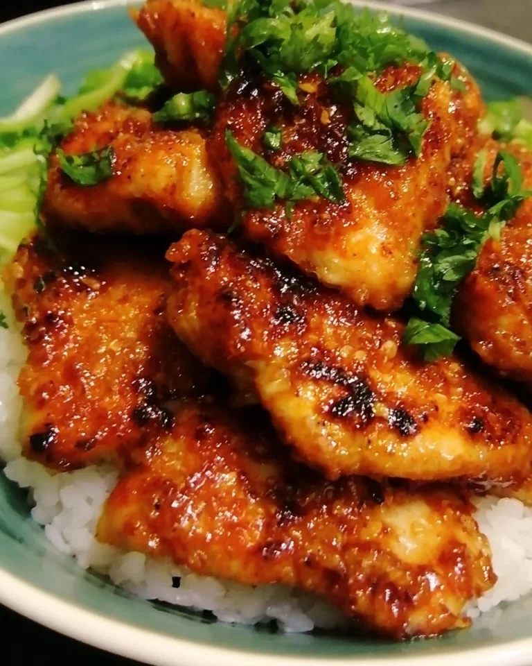 Delicious Honey Garlic Chicken cooked in a savory sauce, served on a plate.