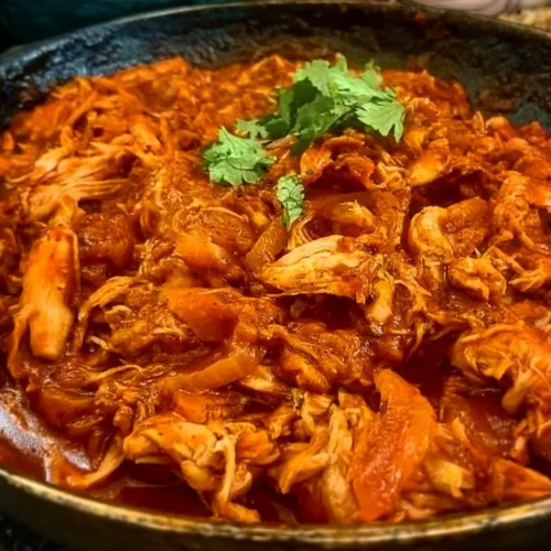 Delicious Minute Chicken Tinga served in a taco with toppings