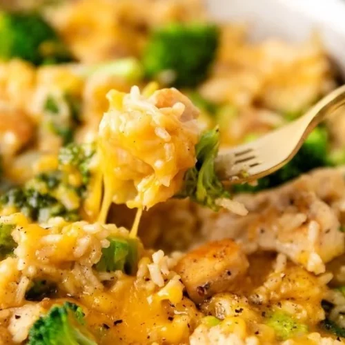 One Pan Cheesy Chicken with Broccoli and Rice dish in a skillet