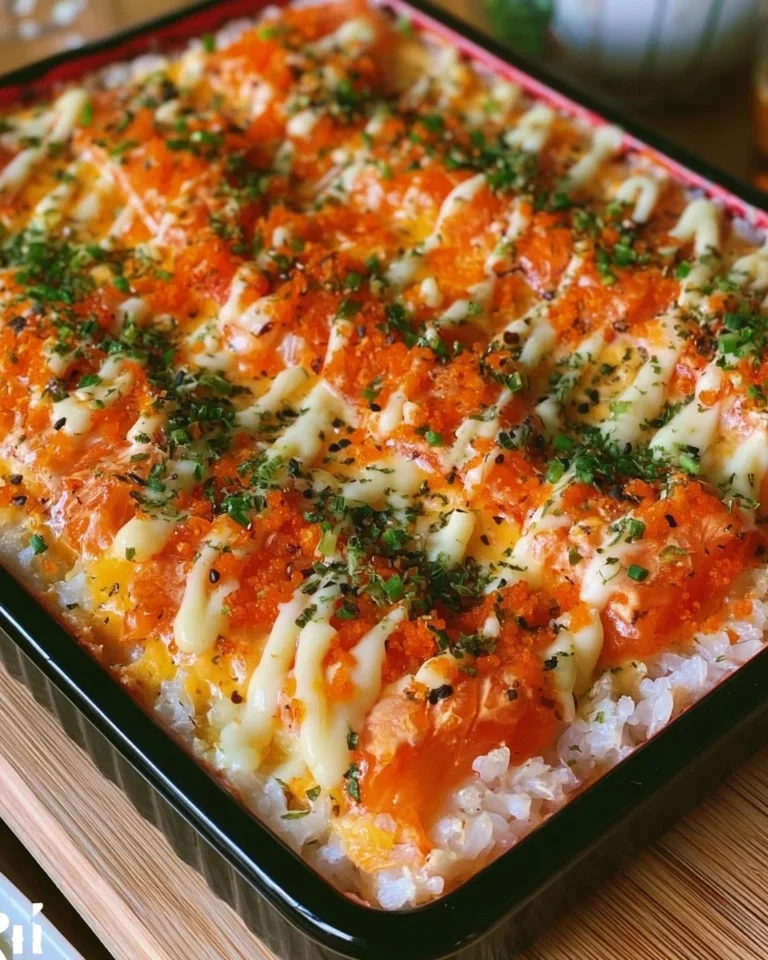 Baked salmon sushi with creamy toppings in a baking dish