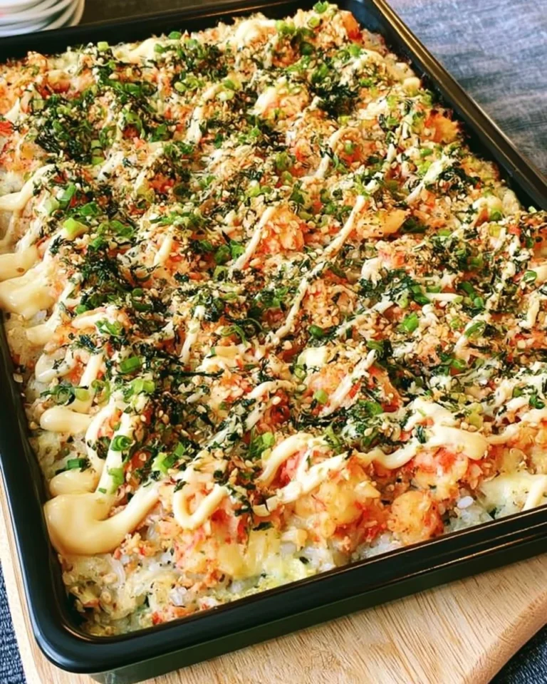 Sushi bake casserole with imitation crab and toppings ready to serve